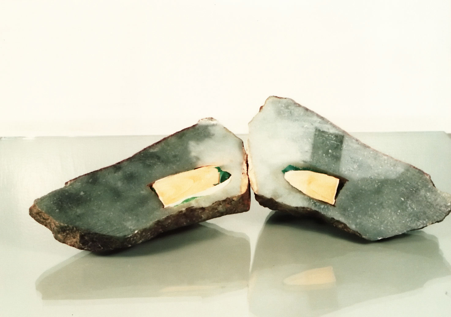 Figure 35. This jadeite boulder had a hole drilled in it from one side to just beneath the surface on the opposite side. A green glue was placed inside near the surface, with a wooden rod added. Then the drill hole was carefully concealed to hide the evidence. Thus when a strong light was shone onto the boulder's surface, a rich green color was revealed. Photos: Richard W. Hughes